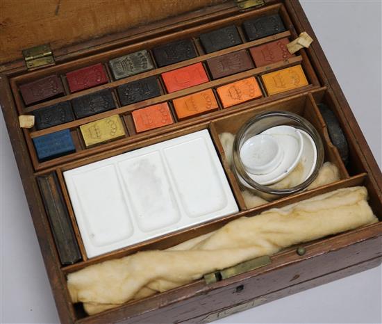 A Newmans artists painting box, with palet and paints H 8.5cm x W 23.5cms
